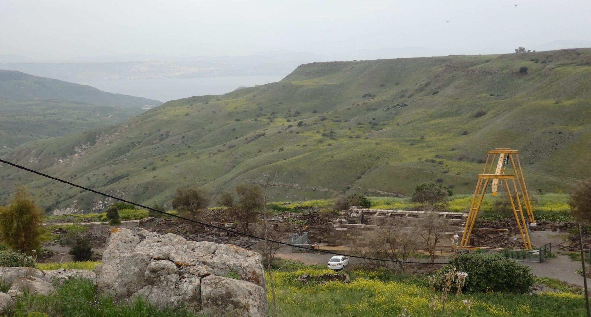 his is the view over the hills of the Golan Heights that opened up once I had descended a short distance down the path from the parking lot. You can see the Sea of Galilee in the haze in the distance. In the foreground is the ruin of the Um el Kanatir synagogue.
