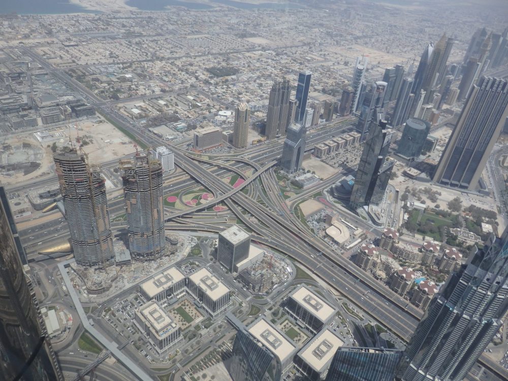 If you look on the left side of this picture, beyond the two towers under construction, you'll see a patch of vacant land, a common sight all over Dubai. Around the highway junction, you can see the carefully-tended greenery that must take an enormous amount of water. Visiting Burj Khalifa