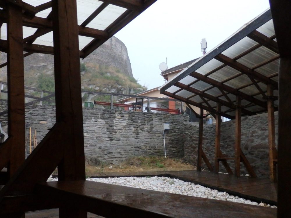My view from where I sat on the ground between the stone wall and a wooden bench. You can see a bit of the cable car station in the background, and the wall of Deva Castle above.