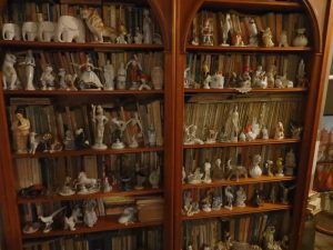 a bookcase full of chotchkes at the Communist Consumers Museum in Timişoara, Romania