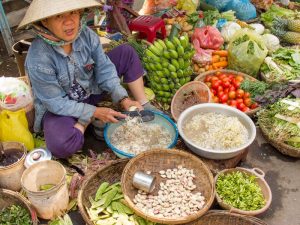 a market vendor in Hoi An, Vietnam. Photo courtesy of Anita Breland of Anita's Feast.