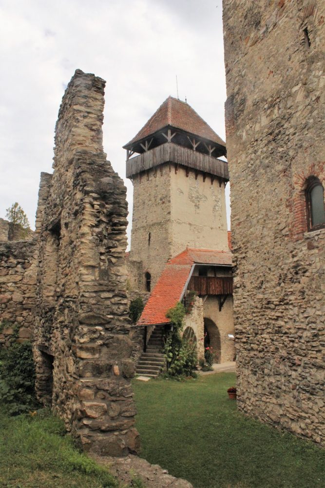 In this picture of Calnic fortified church, you can see a piece of a ruined interior wall, one of the exterior wall towers, and, to the right, the keep. Photo courtesy of Albert Smith.