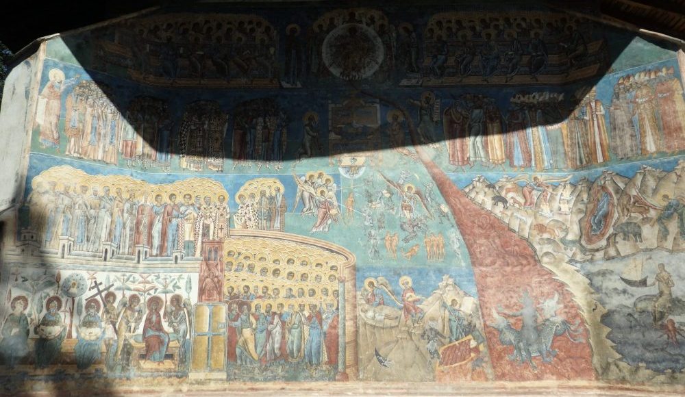 Not the best photo, but here's the bottom half of the wall, showing the river of fire, naked tortured souls, and a multitude of saints. The Spectacular Painted Churches of Moldavia.