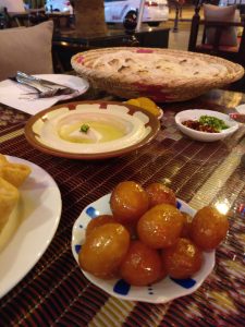 The first part of our meal: hummus in the center, freshly-baked pita behind it, and those balls in the front are some sort of slightly sweet fried dough.