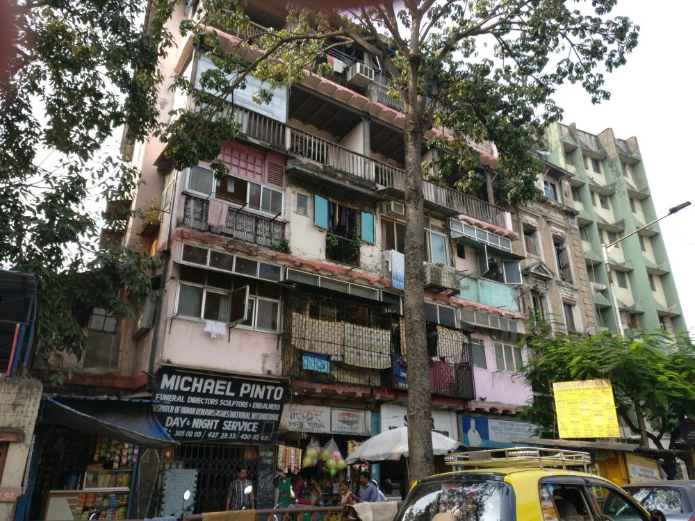 A block of flats somewhere in Mumbai, photographed out a car window.