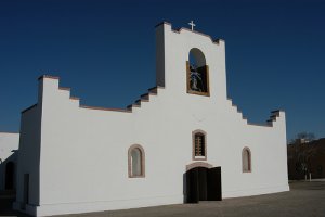 The simple, stepped façade of Socorro Mission. Image via Flickr by misha3637