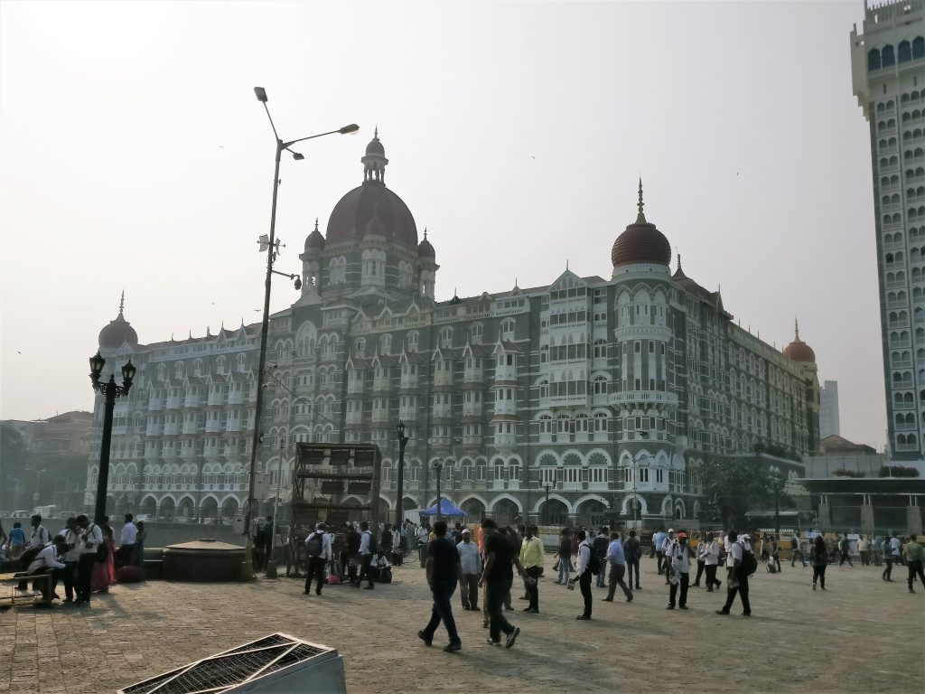 A large and elegant victorian-style building with a dome at its front center and about 7-8 stories high.