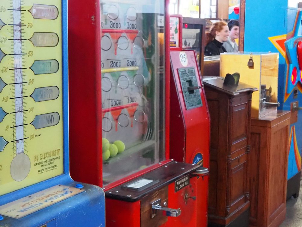 a row of various arcade machines, including the peepshow type, at the Musee Mecanique penny arcade.