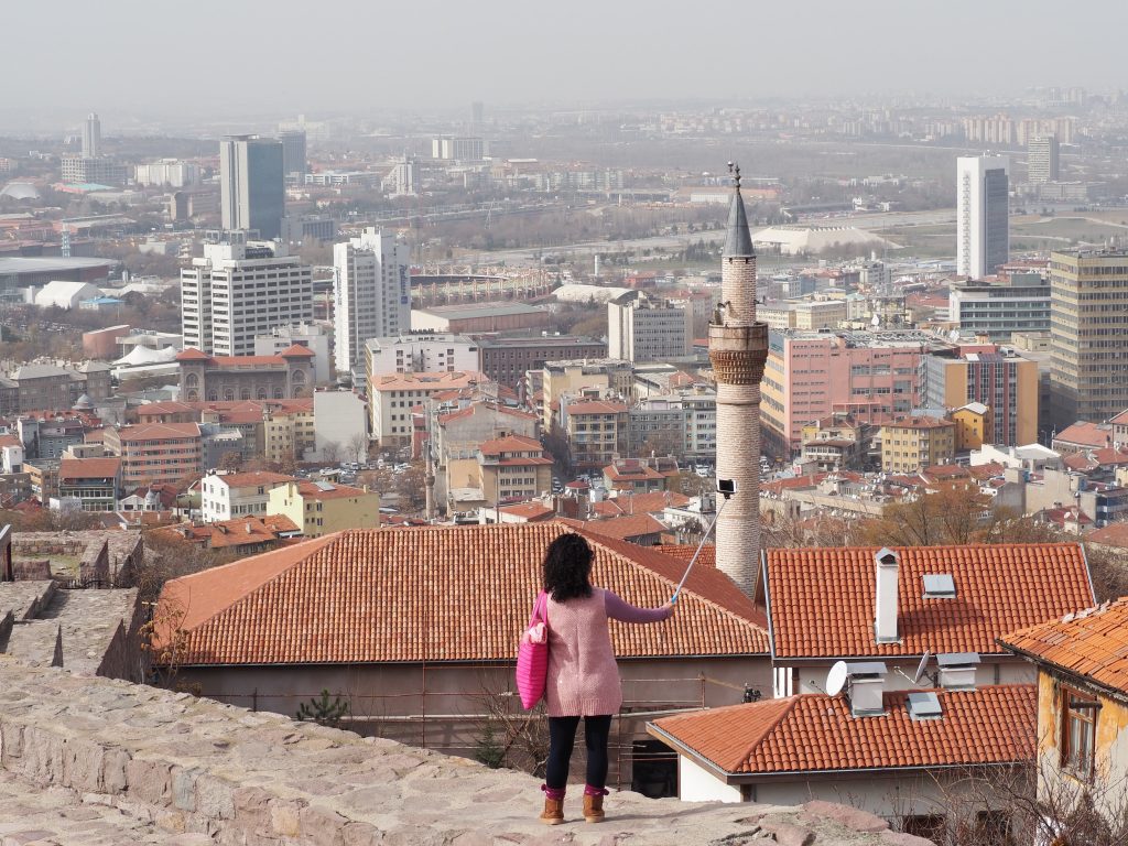 a tourist taking a selfie on a wall of Ankara Castle