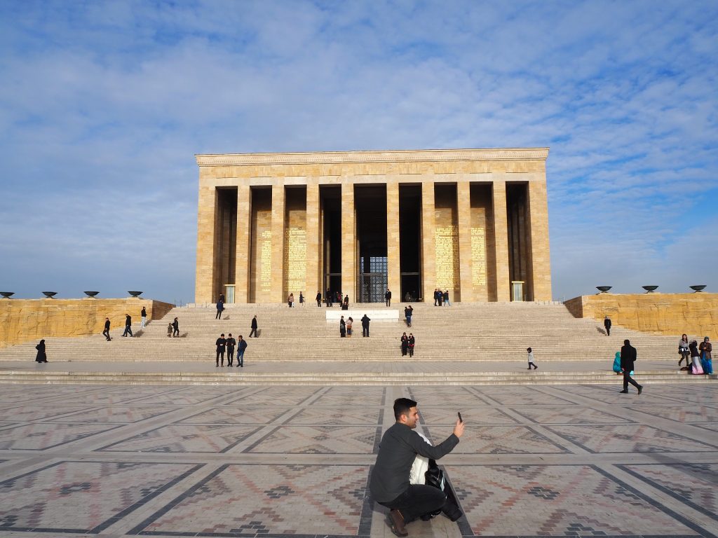 View across the plaza to an imposing building with columns along the front.