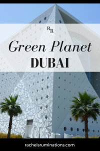 Pinnable image Text: Green Planet Dubai Image: the building: white with round holes, with the corner in the center of the picture. Two palm trees at the bottom of the picture in front of the building.
