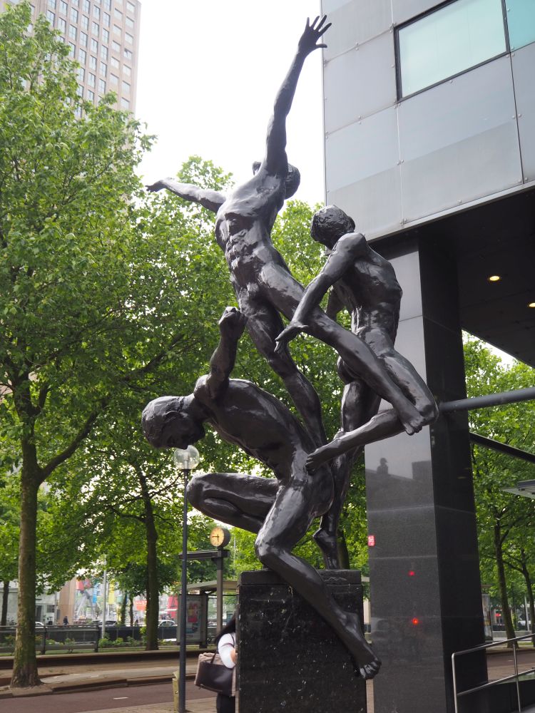 Triumph, by Kees Verkade, is a bronze statue and shows three naked figures in graceful poses, like gymnasts.