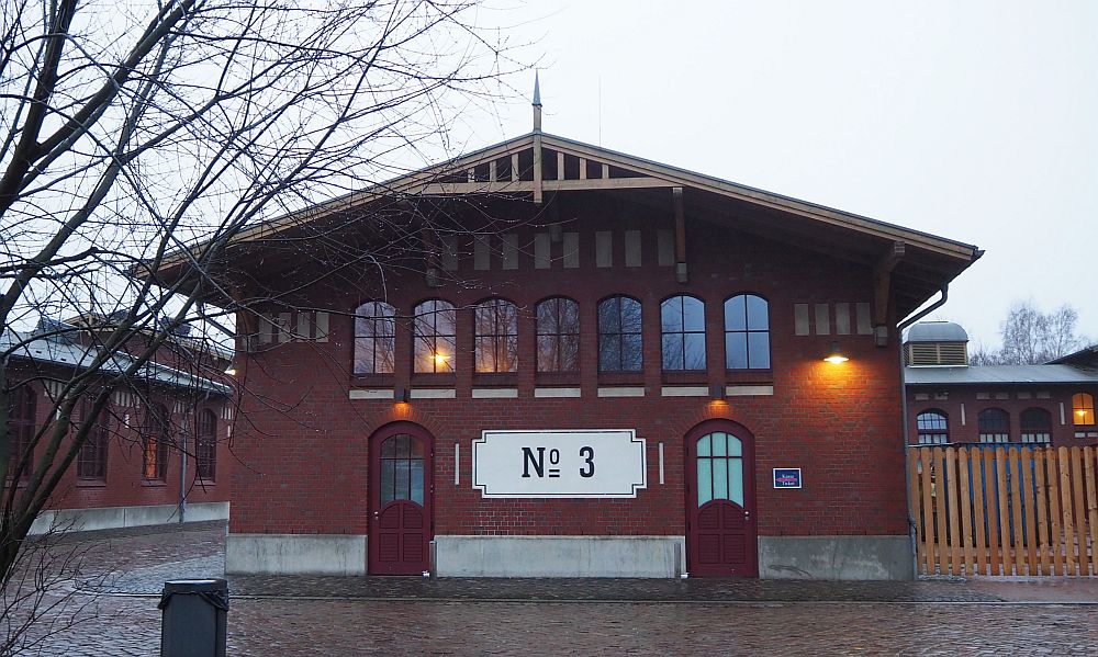 The building is only two stories, with a peaked roof and arched windows.