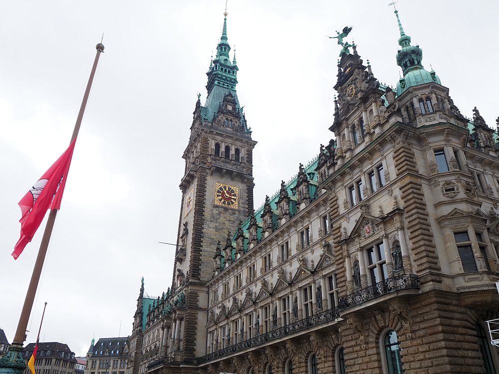 The Rathaus is an ornate building, with a tall tower, copper green roofs and lots of statuary.