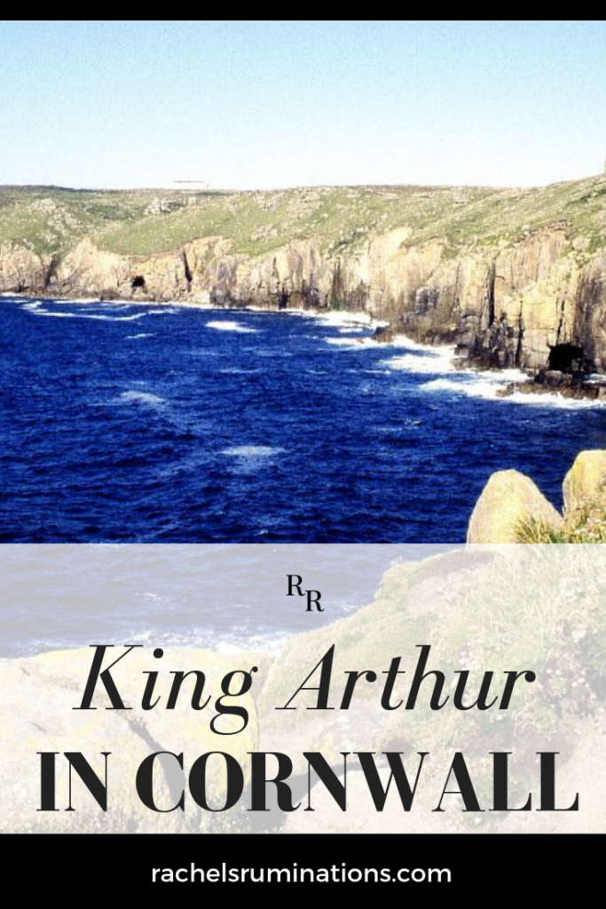 Text: King Arthur in Cornwall. Image: a bay surrounded by rocky cliffs.