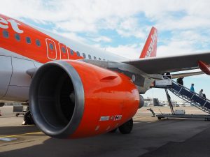 passengers going down the steps from an EasyJet plane.