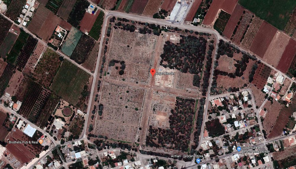 The satellite view shows a neat square, divided in four by roads, and each of those squares shows the outlines of square buildings.