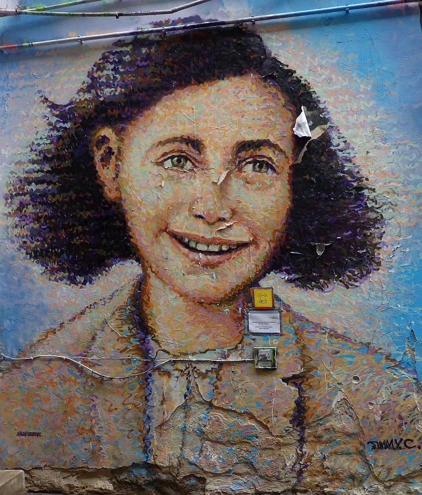 A smiling portrait of Anne Frank.