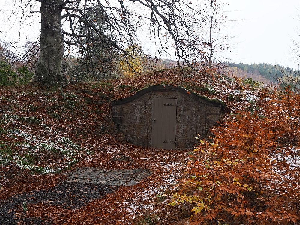 All that is visible is one low wall, since the icehouse is built into a small hill.