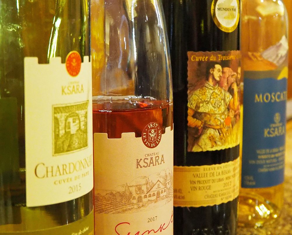 a row of 4 bottles of Chateau Ksara wines