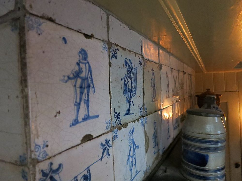 The tiles are a bit chipped around the edges and show simple human figures in blue on a white background.