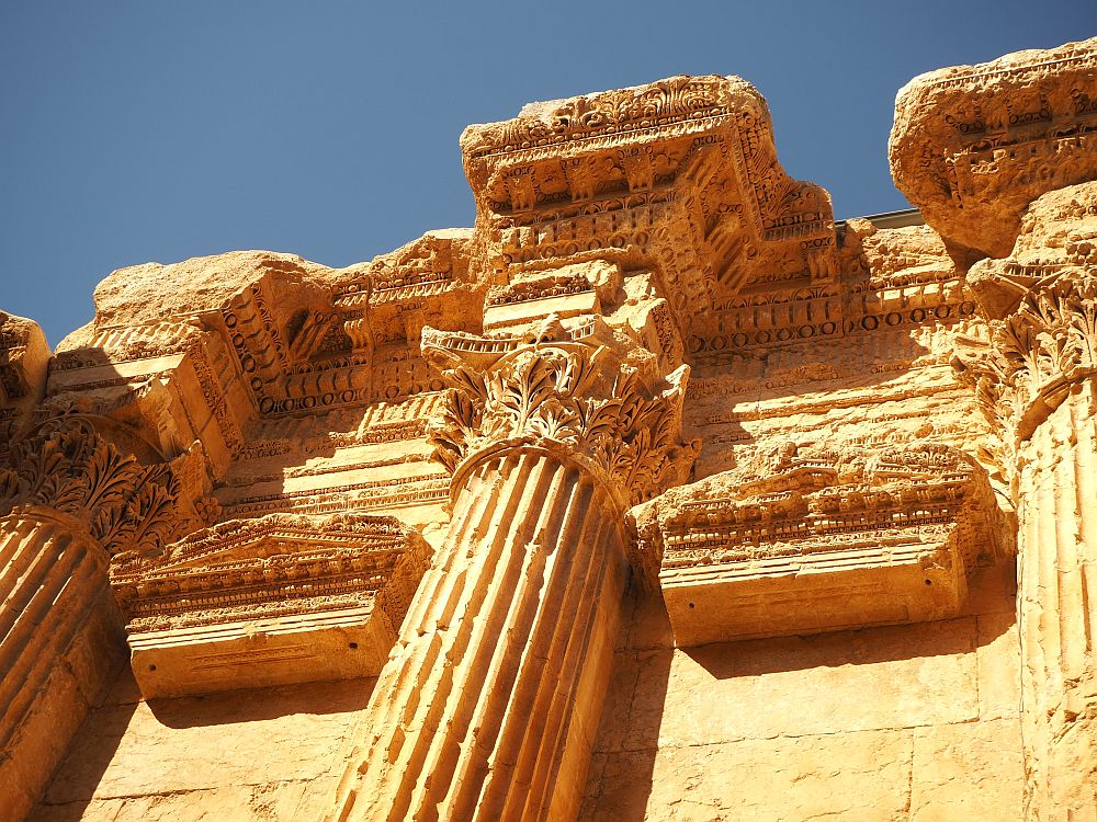 A very ornate Corinthian capital and more ornate stonework above it. Baalbek ruins in Lebanon.