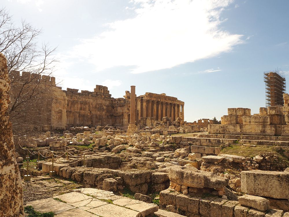 Most of this view is rubble: bits and pieces from what used to be the Temple of Jupiter. An altar is visible in the background with a row of columns. Great Court in Baalbek Ruins, Lebanon.