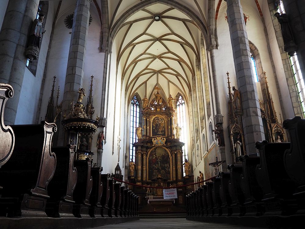 The gothic interior of St. Vitus Church in Cesky Krumlov has an enormous baroque altarpiece.