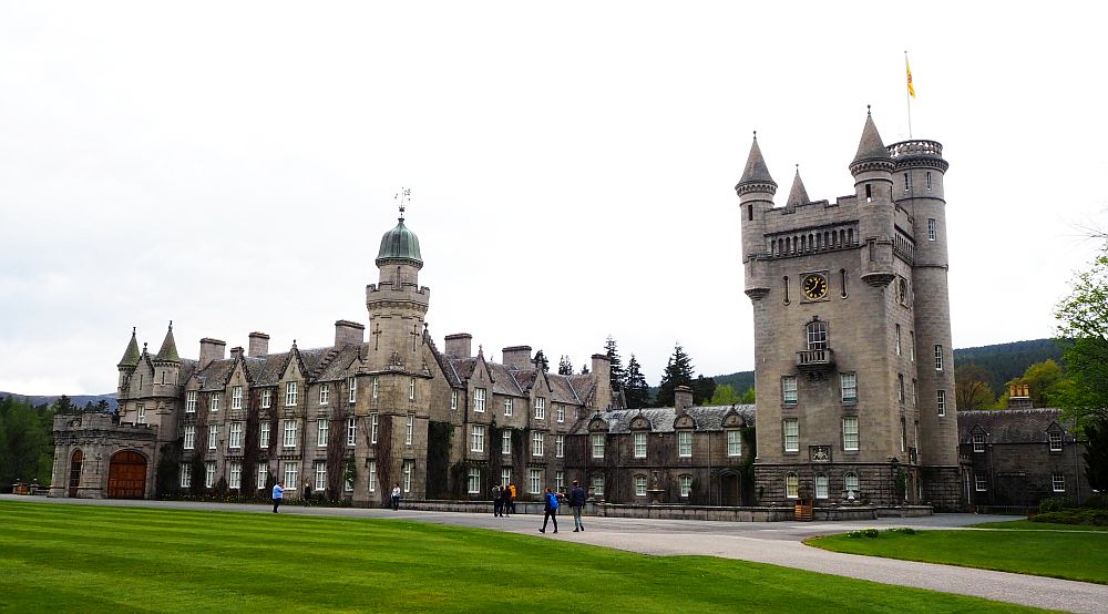 A sprawling castle with one big square, crenellated tower.