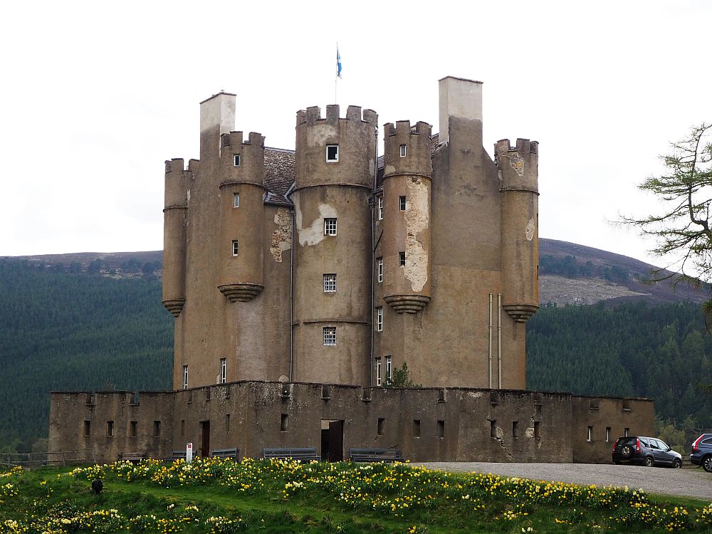 a compact, vertical castle with rounded towers and crenellations