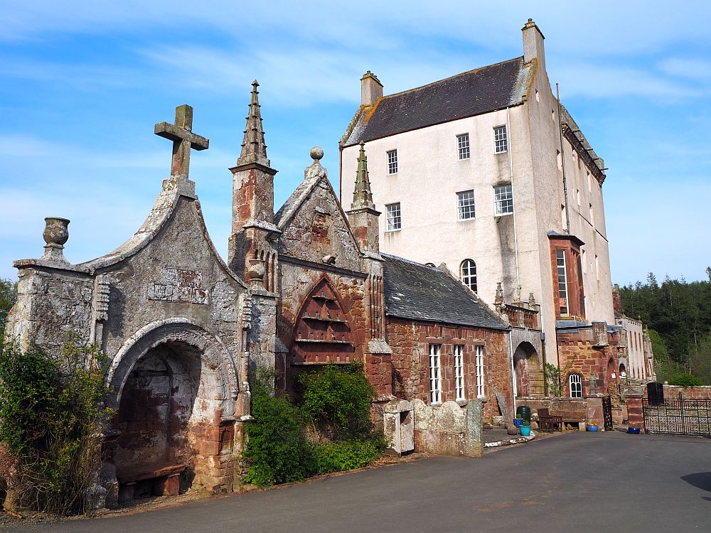 a row of assorted additions in stone have been added to the original tower house, which is behind the additions in this photo.