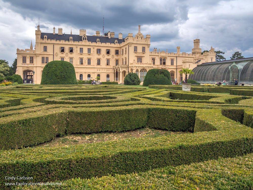 Another grand white walled castle, with a formal garden in the foreground