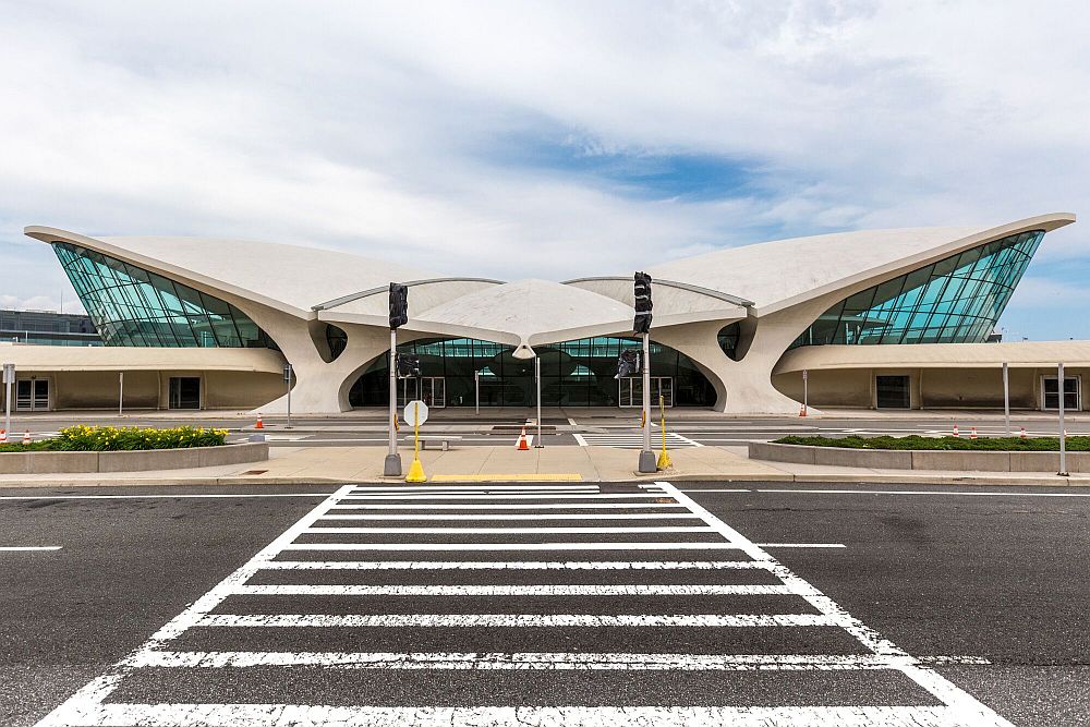 Front view shows the white curve of the TWA terminal building.