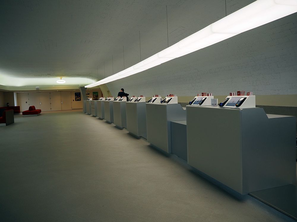 A long row of counters: white, with a white floor and a white wall behind and at the end in the distance.