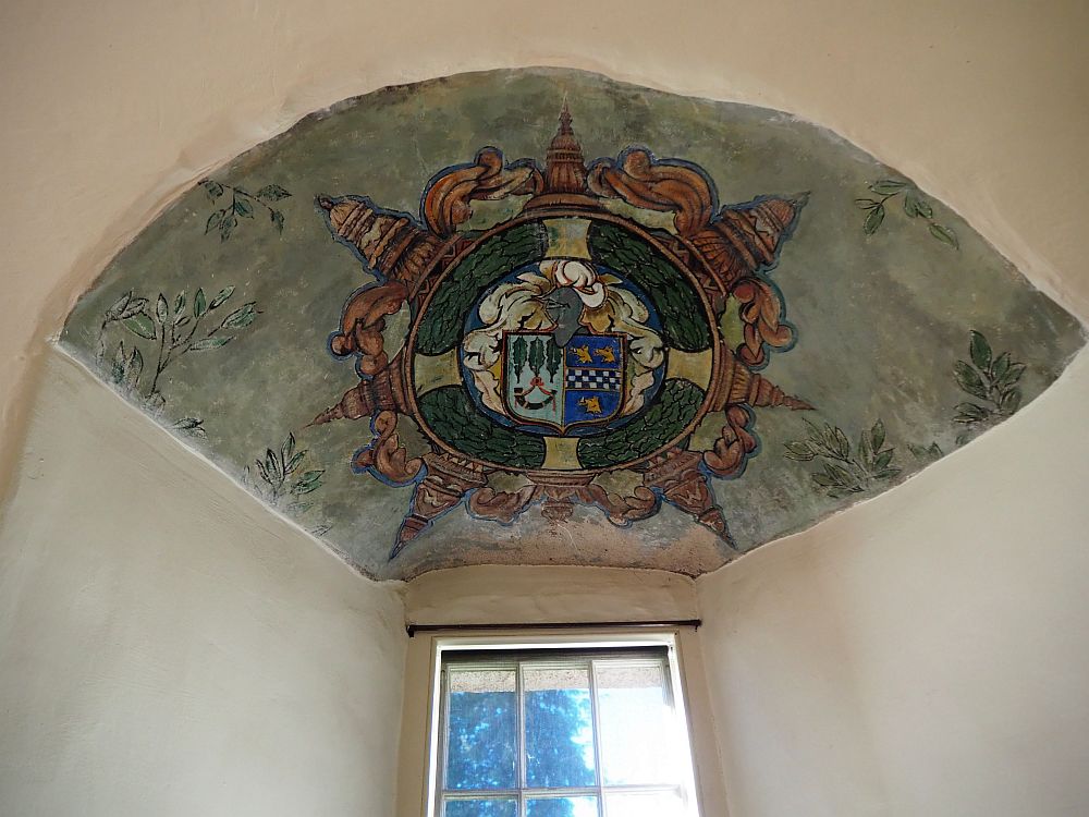 The painting that remains shows a coat of arms on the small ceiling above the window, which is set in a thick wall at Crathes Castle in Scotland