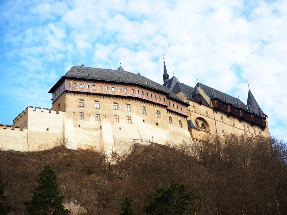 In this view, more of the walls are visible and less of the towers. Visiting Karlstejn Castle from Prague