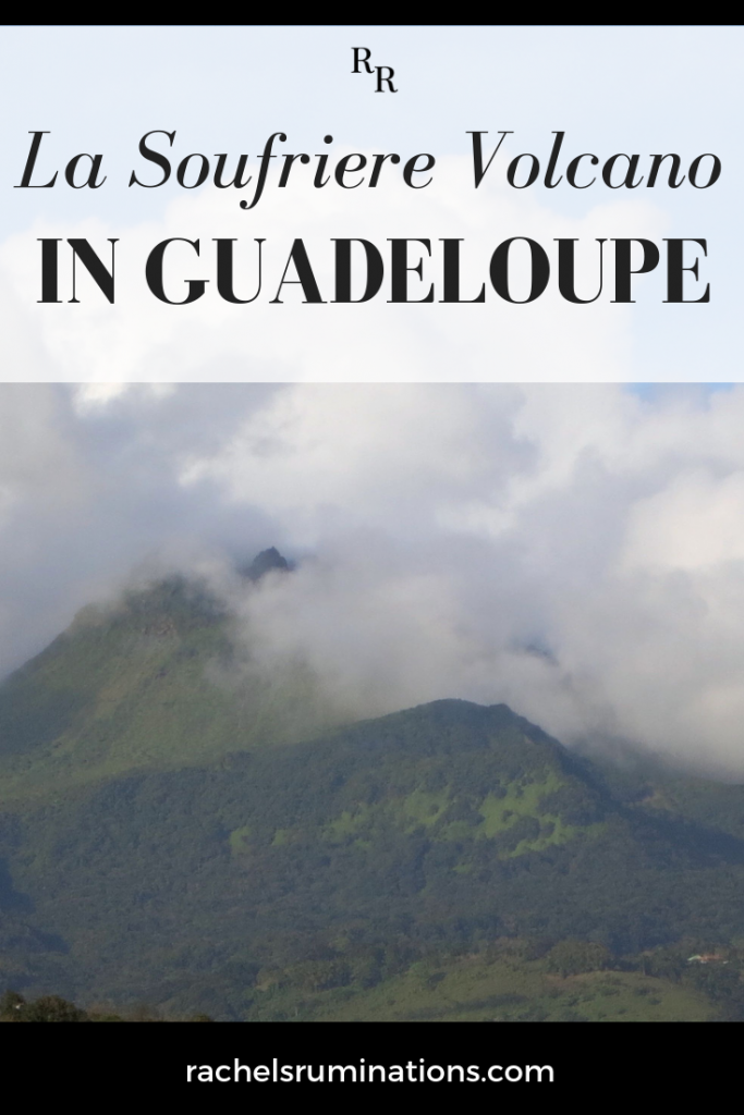 Pinnable image
Text: La Soufriere Volcano in Guadeloupe
Image: the green sides of the mountain, topped with clouds.