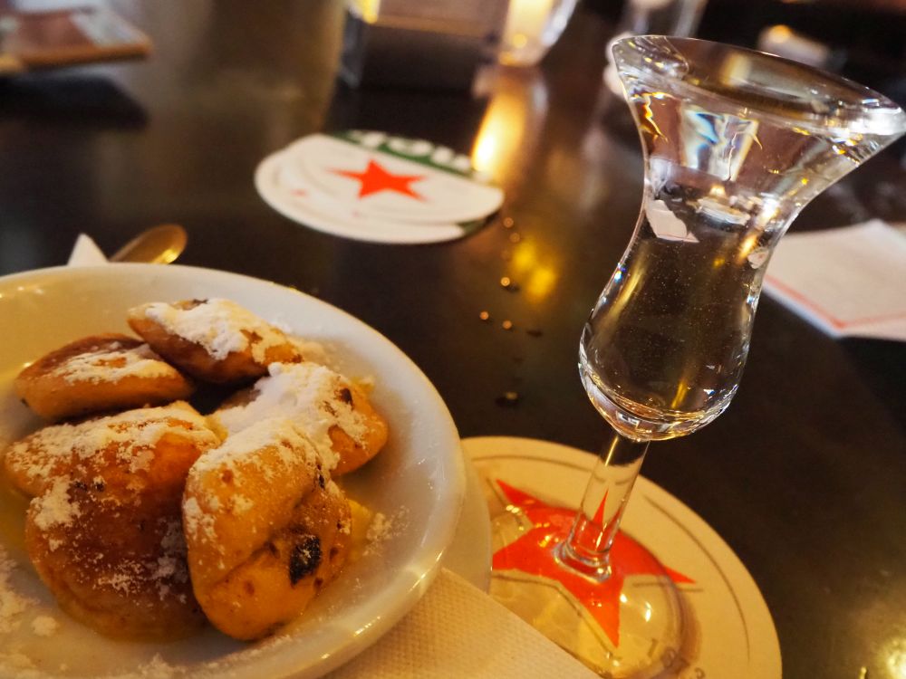 On the left, a white plate with poffertjes piled on it, dusted with sugar. On the right, a tulip-shaped glass, filled to the brim with a clear liquid. I think this may have been my favorite stop on the Jordaan food tour.