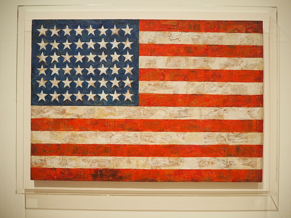 A depiction of an American flag, but painted and seeming smudged.