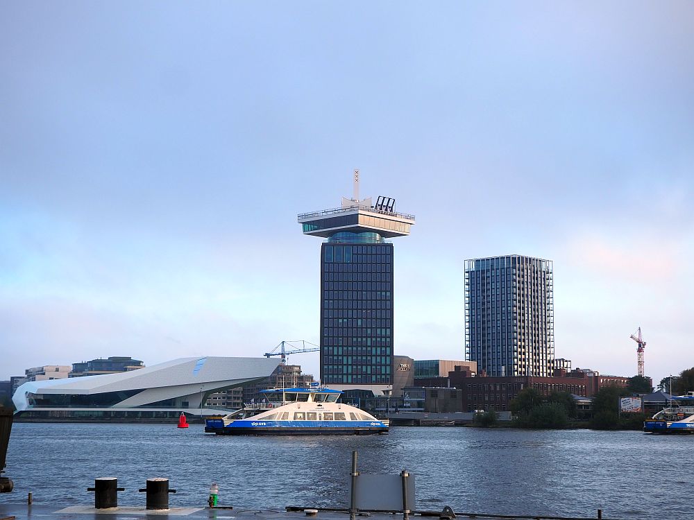 Seen from across the river, the sleek Eye Museum building and the tall ADam lookout.