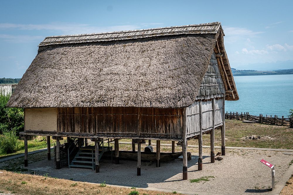 A thatch-roofed, wood-sided hut, standing on stilts.