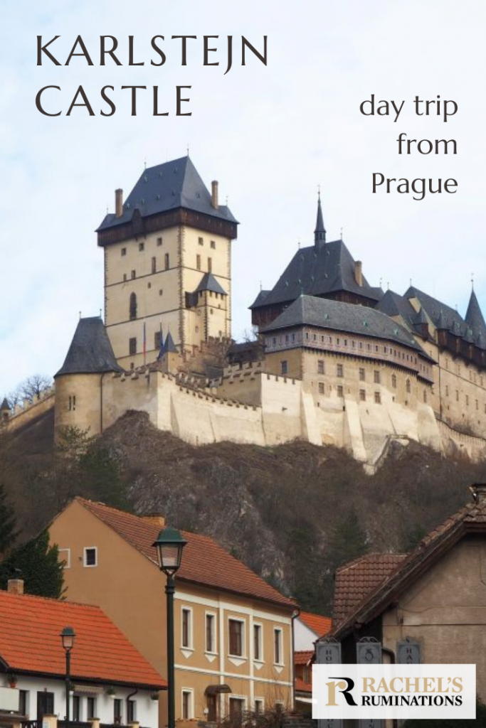 Pinnable image
Text: Karlstejn Castle, day trip from Prague
Image: view up to the castle, with the village at the bottom and the castle looming above it.