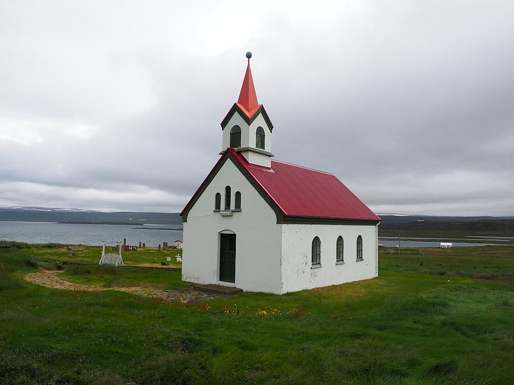 Another picturesque Icelanding church: white with a red roof. This time the steeple isn't attached on the end above the entrance vestibule, like most of them, but added on one end of the roof's peak.