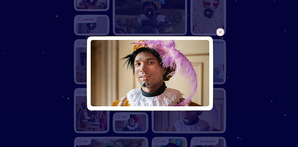 A portrait shot of a white man with smears of dirt on his face. He has straight black hair (or it's a wig; I can't tell) sticking out from his puffy beret with a big pink feather hanging off of it.