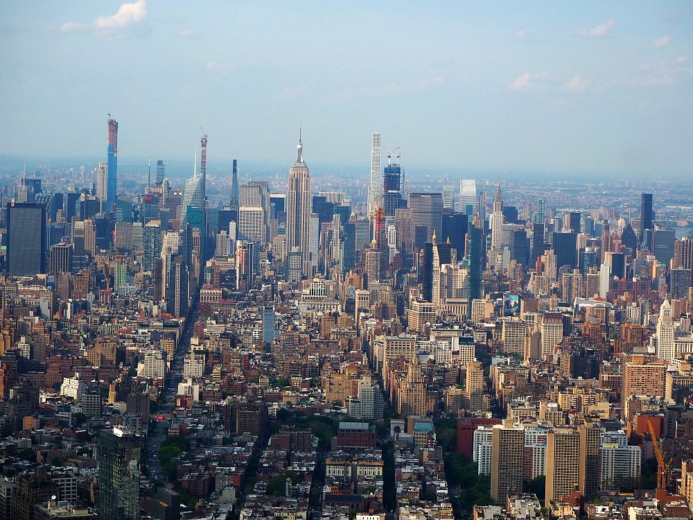 Buildings and streets into the distance. The nearer ones are less tall, but in the middle distance there are lots of tall ones, including the Empire State Building in the center. Taken from the 9/11 memorial site.