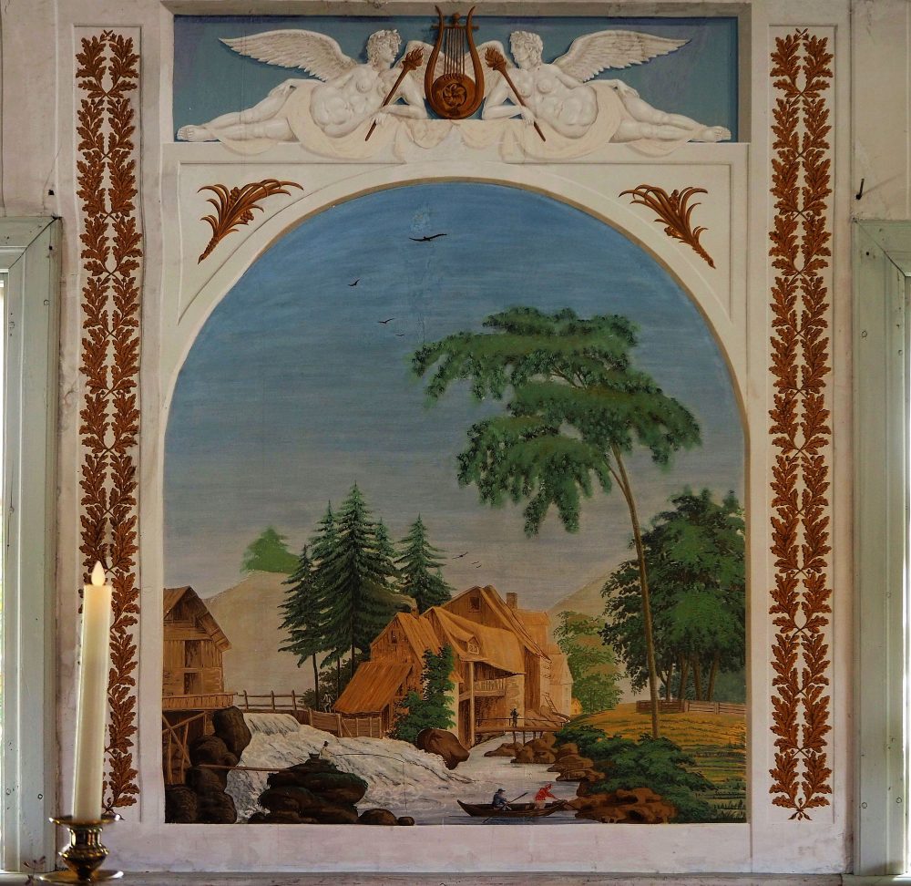 The mural shows a rural scene: a thatched house next to a waterfall with trees around it. Above are two reclining angels that look 3-dimensional.