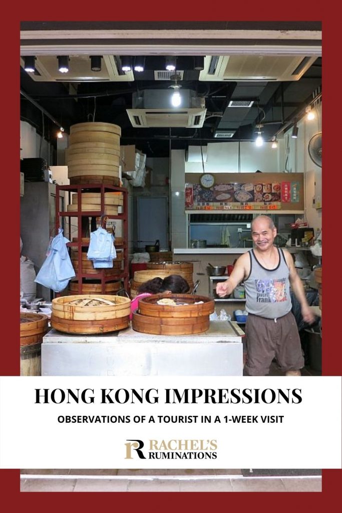 Text: Hong Kong Impressions: Observations of a tourist in a 1-week visit (and the Rachel's Ruminations logo)
Image: a man smiles as he points at a basket full of dim sum in the storefront shop he runs. The view shows the whole interior of the kitchen where he prepares the dim sum.