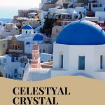 Text: Celestyal Crystal Cruise: A review. Image: a view in Santorini: white houses, blue domes.