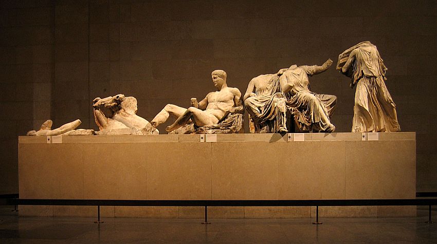 From left to right, the figures show a horse (dying, perhaps, because it is low to the ground), a naked man reclining, missing a hand but otherwise intact; and three figures that are draped in cloth (togas?) but all of these are missing their heads and limbs. Originally the set would have fit into a pediment, so the figures are lower on the left and taller on the right.