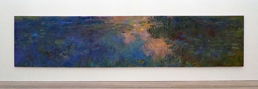 An impressionistic horizontal view, very long and thin. It seems to show a body of water with green plants (water lilies?) growing on it and clouds reflected in the parts that are not covered with plants.